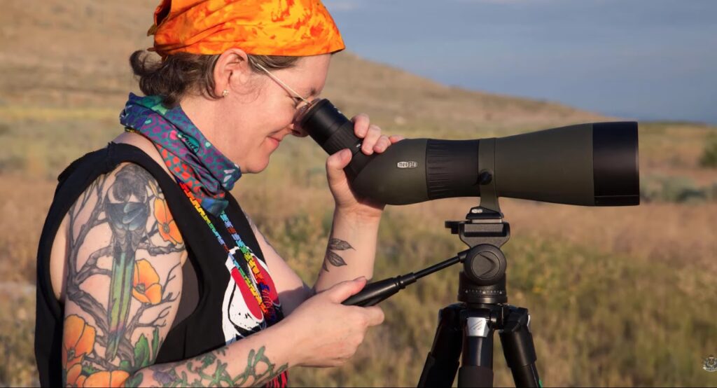 a woman looking through the scope